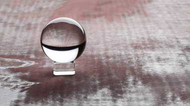 Magic crystal ball on brown background