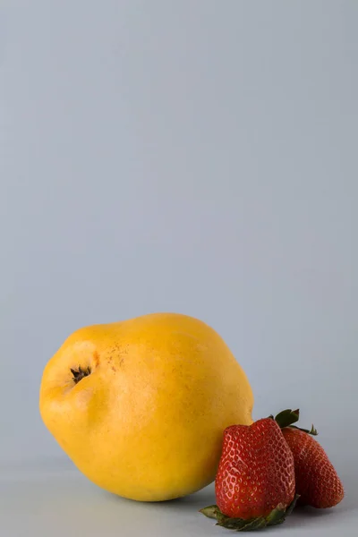 Trendy Ugly Organic Fruit Quince Strawberry Blue Background Horizontal Orientation — Stock Photo, Image