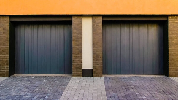 New brick garage with roller shutters for two car