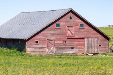 An old barn in a grassy field