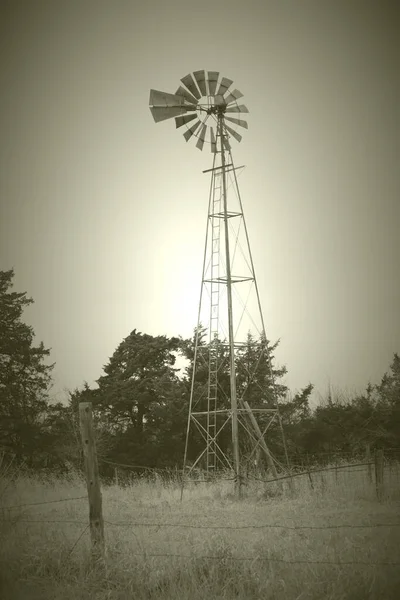 Old-time photo of an old Windmill in Nebraska farmland scape
