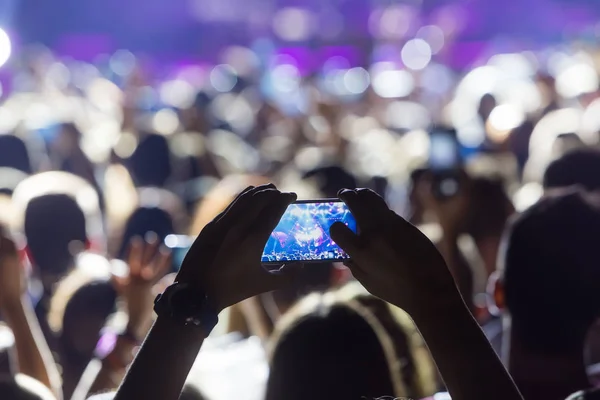 Mano con un smartphone graba música en vivo festiva — Foto de Stock