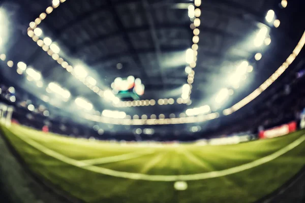 Blurred field with lights and full of spectators at the stadium — Stock Photo, Image