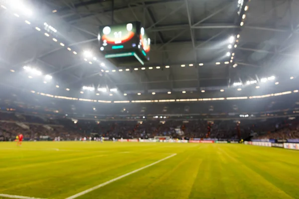 Campo desfocado com luzes e cheio de espectadores no estádio — Fotografia de Stock