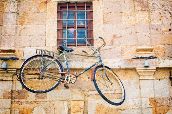 Vintage bike hanging on a wall — Stock Photo, Image