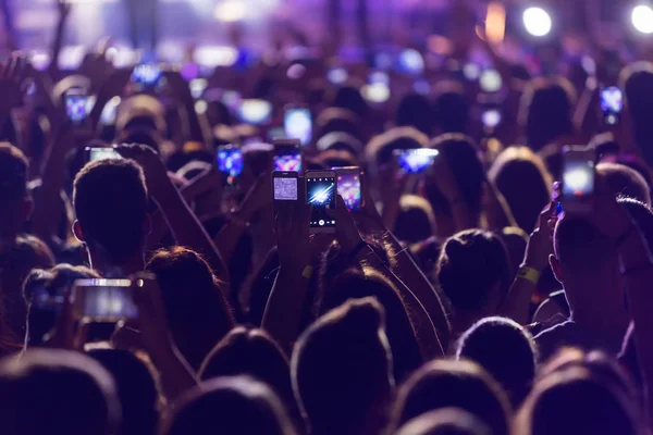 Hand met een smartphone records live muziekfestival — Stockfoto
