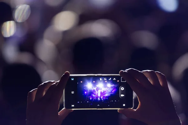 Hand with a smartphone records live music festival — Stock Photo, Image