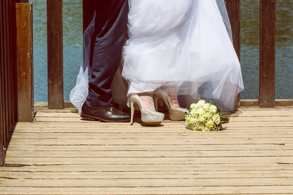 feet of bride and groom, wedding shoes