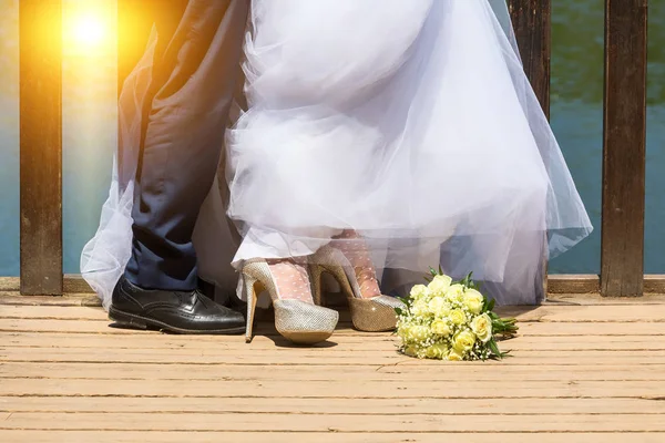 feet of bride and groom, wedding shoes