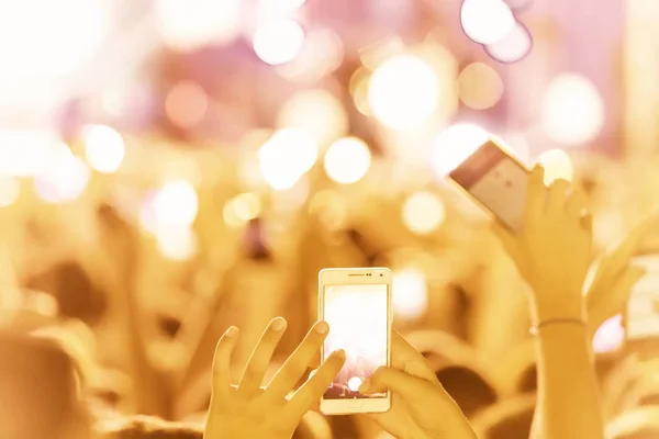 Hand with a smartphone records live music festival — Stock Photo, Image