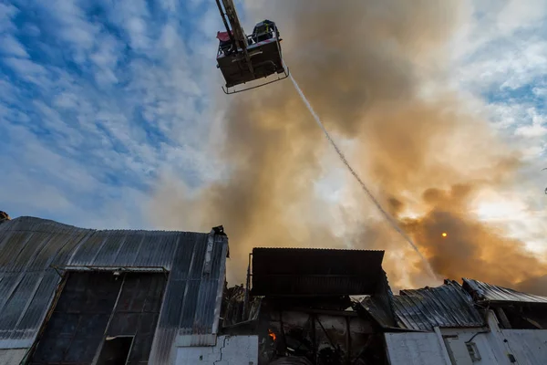 Feuerwehrleute tun sich schwer, das Feuer zu löschen, das in dem Haus ausbrach. — Stockfoto