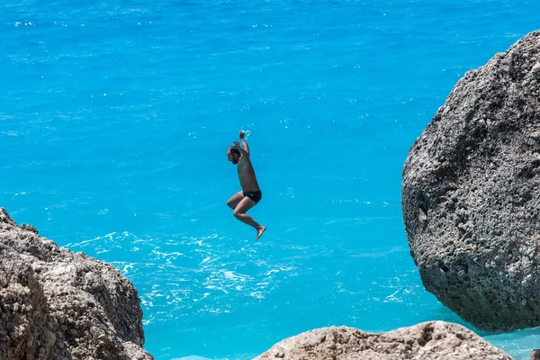 People to jump playing in the sea at the Kavalikefta Beach in Le — Stock Photo, Image