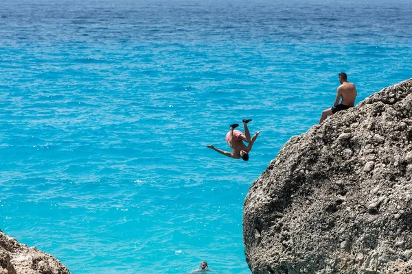 People to jump playing in the sea at the Kavalikefta Beach in Le Stock Picture