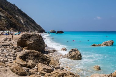 İnsanlar Lefkada Isla Megali Petra Beach'te denizde yüzmek