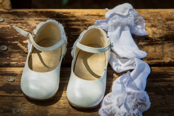 Zapatos y calcetines blancos para niños sobre fondo de madera —  Fotos de Stock
