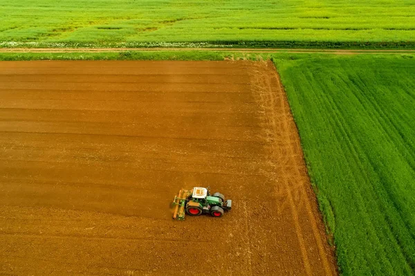 Antenn skott av bonden med en traktor på jordbruksområdet — Stockfoto