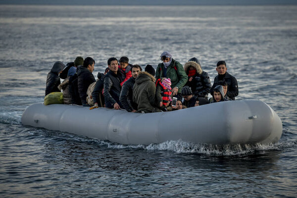 Lesbos, Greece, March 2, 2020: Refugees and Migrants aboard reach the Greek Island of Lesbos after crossing on a dinghy the Aegean sea from Turkey