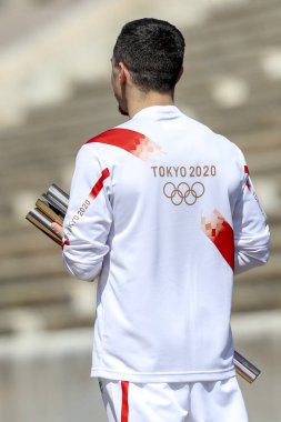 Atina, Yunanistan - 19 Mart 2020: Tokyo 2020 Yaz Olimpiyatları için Olimpiyat Alev devir töreni. Yunan Olimpiyat madalyası sahibi E. Petrounias, Panathenaic Stadyumu 'nda Tokyo Olimpiyat Alevi' ni düzenledi.