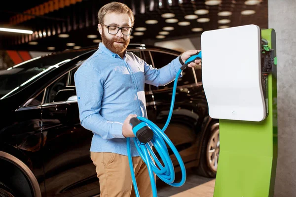Man choosing car charger at the car dealership