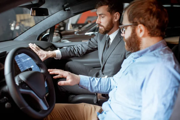 Gerente de ventas con un cliente mirando el interior del vehículo — Foto de Stock