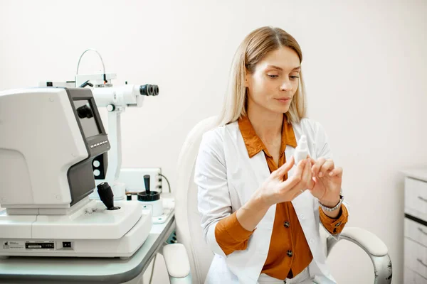 Ophthalmologist with eye medicine in the office