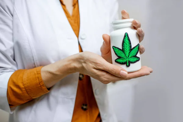 Holding a bottle with marijuana medication — Stock Photo, Image