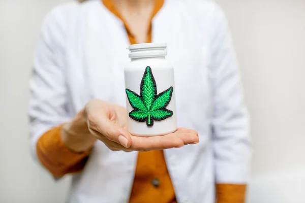 Holding a bottle with marijuana medication — Stock Photo, Image