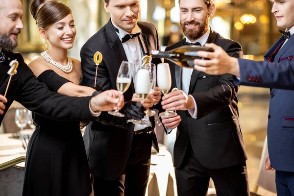 Well-dressed people celebrating New Year indoors — Stock Photo, Image