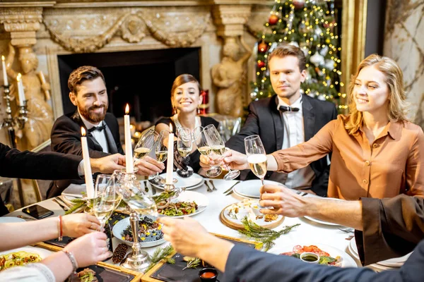 Elegantly dressed people celebrating New Year holiday indoors — ストック写真