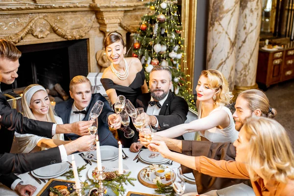 Elegantly dressed people celebrating New Year holiday indoors — ストック写真