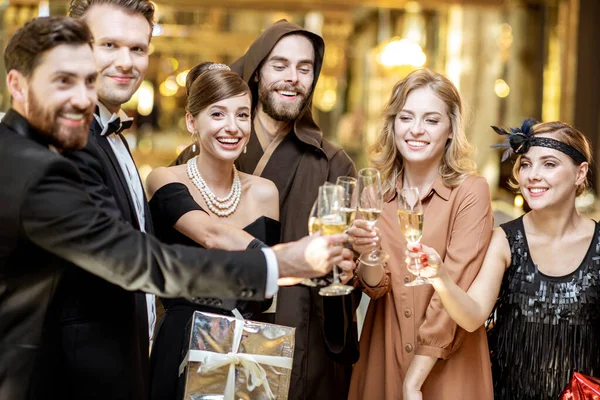 Well-dressed people celebrating New Year indoors — ストック写真