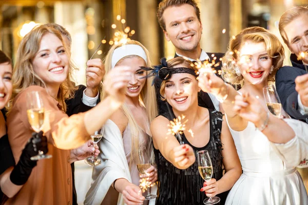 Well-dressed people celebrating New Year indoors — ストック写真