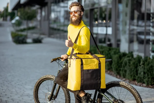 Courier portrait with bicycle and bag outdoors