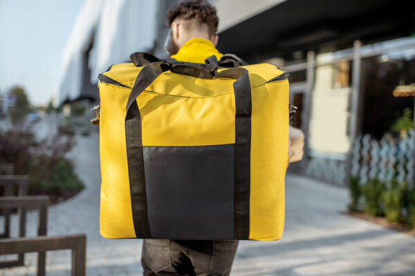 deliveryman with backpack outdooors