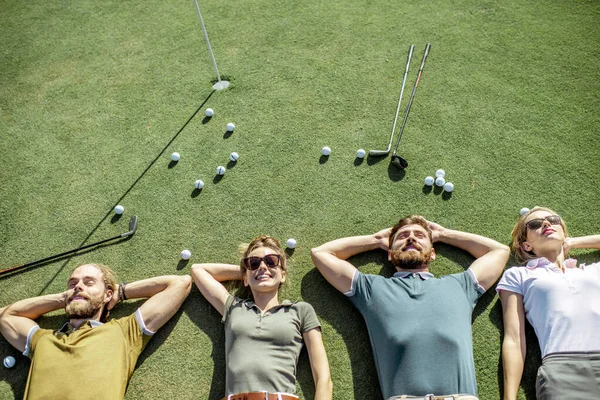 Amigos acostados en el campo de golf —  Fotos de Stock