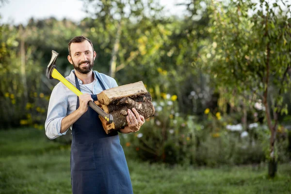 Maderero con hacha y madera al aire libre — Foto de Stock