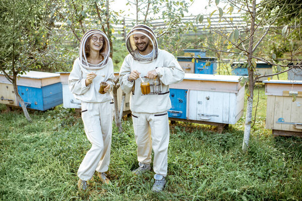 Beekeepers with honey on the apiary