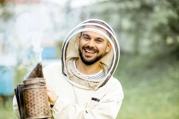 Beekeeper with bee smoker on the apiary — Stock Photo, Image