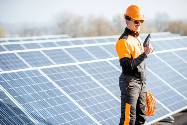 Well-equipped workman on a solar station — Stock Photo, Image