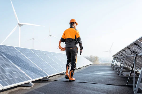 Well-equipped workman on a solar station — Stock Photo, Image