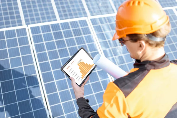 Examining production of solar power plant with digital tablet