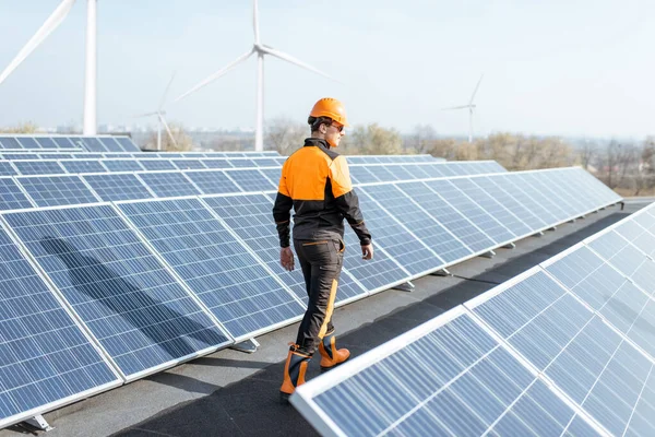 Well-equipped workman on a solar station — Stock Photo, Image
