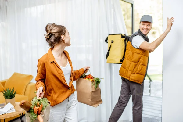 Courier entrega de comestibles frescos a casa para un cliente joven , —  Fotos de Stock