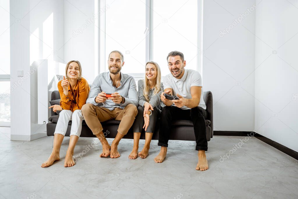 Friends playing video games at home