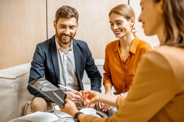 Young couple with sales manager in the office