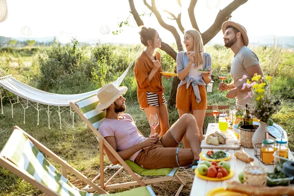 Friends during a festive lunch in the garden — Stock Photo, Image