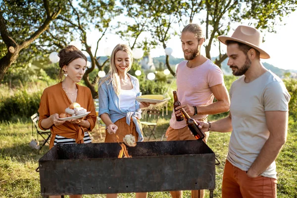 Friends having barbecue in the garden — Stock Photo, Image