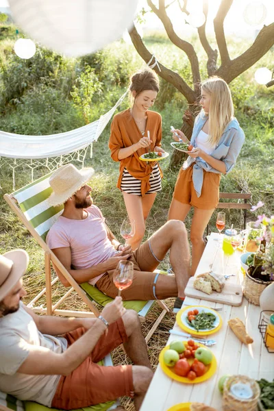 Barátok ünnepi ebéd közben a kertben — Stock Fotó