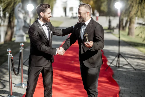 Film actors on the red carpet outdoors — Stock Photo, Image