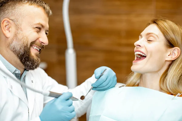 진찰중에 치과 의사가 미소를 짓고 있는 성인 환자 — 스톡 사진